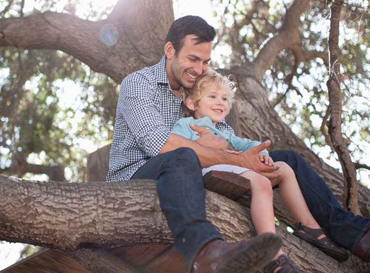 Man with small child in tree